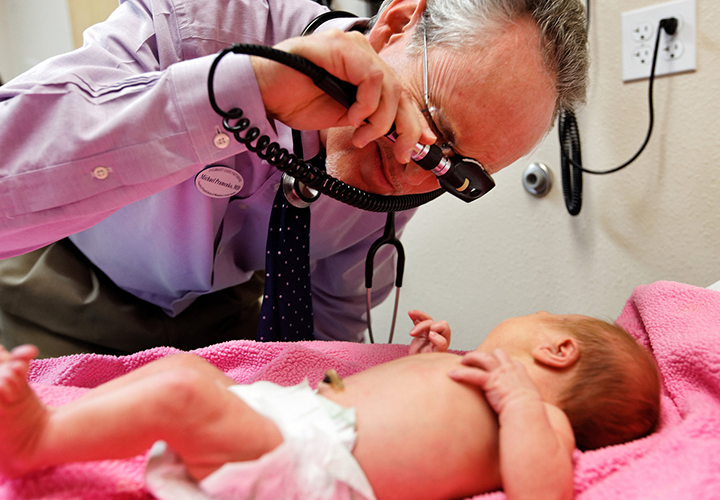 Dr. Michael Pramenko, of Family Physicians of Western Colorado in Grand Junction, examines a young patient. 