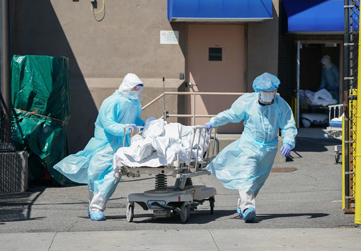 Bodies are moved to a refrigeration truck serving as a temporary morgue at Wyckoff Hospital in Brooklyn, N.Y., on April 6, 2020.