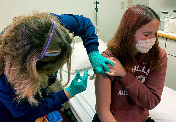 A volunteer receiving the Pfizer-BioNTech vaccine during the company’s clinical trial at Cincinnati Children’s Hospital Medical Center in October.